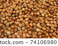 Forest nut background. Full and half of hazelnuts on white background top view. Isolated 74106980