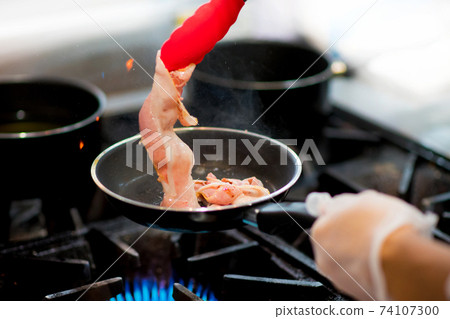 fresh fried bacon in a pan, Chef cooking in the kitchen 74107300