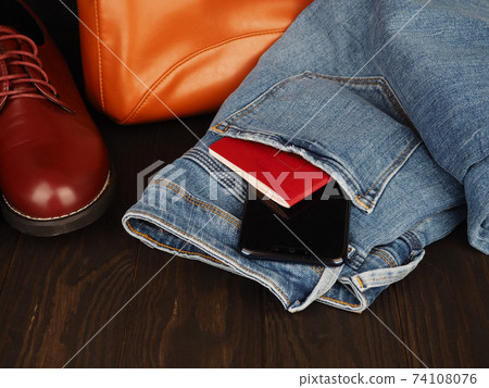 men's leisure concept, jeans, leather shoes, passport and phone, place for design men's leisure concept, jeans, leather shoes, passport and phone, place for design 74108076