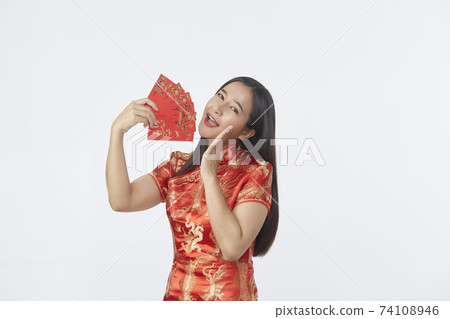 Asian woman in traditional red cheongsam dress Asian woman in traditional red cheongsam dress 74108946