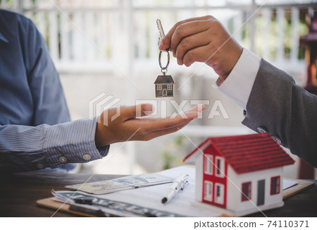 House signers signing signature loan document to home ownership with real estate agents ownership. Mortgage and real estate property investment, home insurance 74110371
