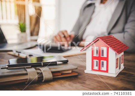 Close up hand signing signature loan document to home ownership. Mortgage and real estate property investment, home insurance ,security. 74110381