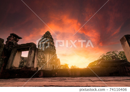 Selective focus on Phimai Historical Park with sunset sky. Landmark of Nakhon Ratchasima, Thailand. Travel destinations. Historic site is ancient. Ancient building. Khmer temple classical architecture 74110406