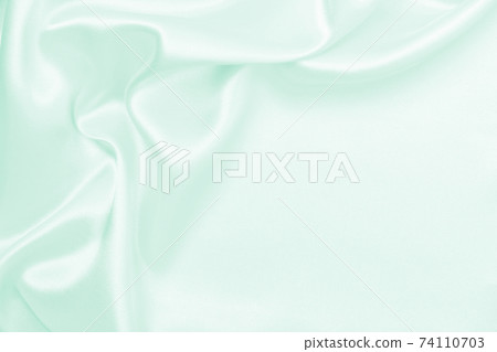 Smooth elegant green silk or satin luxury cloth texture as abstract background. Luxurious background design Smooth elegant green silk or satin luxury cloth texture as abstract background. Luxurious background design 74110703