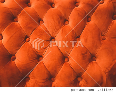 close-up orange leather sofa backrest background 74111262