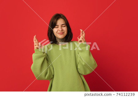 Caucasian woman's portrait isolated on red studio background with copyspace 74112239