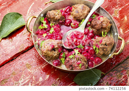 Lamb meatballs in cherry sauce 74112256