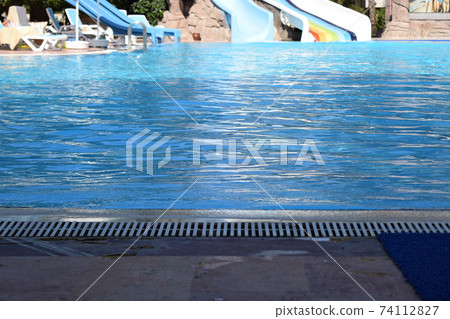 Swimming pool in touristic resort during summer time. Swimming pool in touristic resort during summer time. 74112827