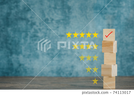 star rating and wooden cubes with blue background, satisfactory survey concept 74113017