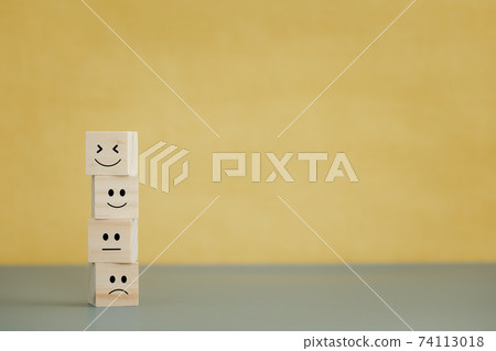 emotion faces on wooden cubes for satisfaction survey 74113018