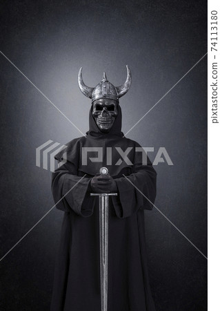 Skeleton warrior with horned helmet and sword in the dark Skeleton warrior with horned helmet and sword in the dark 74113180