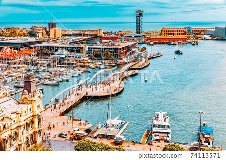 BARCELONA, SPAIN - SEPTEMBER 03: View of the embankment of Barcelona and the bridge "Sea Rambla"  in September 03, 2014 in Barcelona, Catallonia, Spain. The most popular place to walk for tourists. 74113571