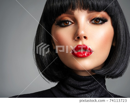 Beautiful brunette girl with red lips and black bob hairstyle. Pretty young woman with black hair. Closeup portrait of a model with bright makeup on a face. Fashion portrait of a pretty lady. Beautiful brunette girl with red lips and black bob hairstyle. Pretty young woman with black hair. Closeup portrait of a model with bright makeup on a face. Fashion portrait of a pretty lady. 74113723