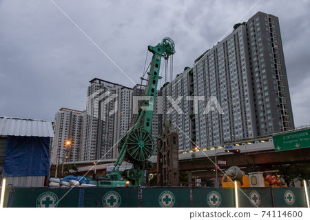 Construction, repair of a road in a residential area of the city. Road construction machinery at the construction site of a new road. 74114600