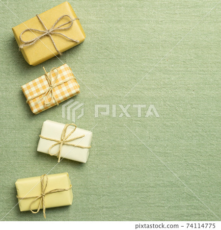 Yellow gift boxes on green fabric background. flat lay, top view, copy space Yellow gift boxes on green fabric background. flat lay, top view, copy space 74114775