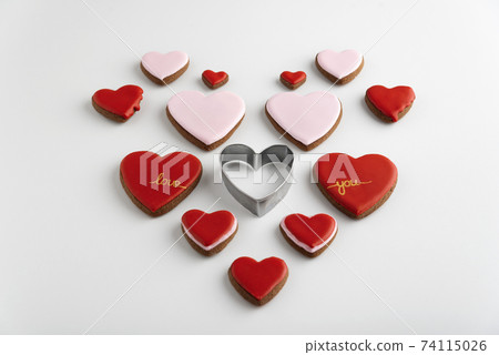 Many heart-shaped cookies with color sugar icing. White background. Valentines day treat. 74115026