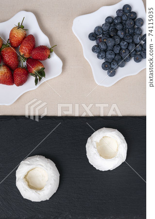 Ingredients for meringue cakes with berry . Cake Anna Pavlova. Top view. Vertical frame Ingredients for meringue cakes with berry . Cake Anna Pavlova. Top view. Vertical frame 74115035