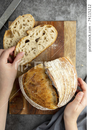 Sourdough rustic bread. Traditional homemade bread, top view, copy space. Sourdough rustic bread. Traditional homemade bread, top view, copy space. 74115212