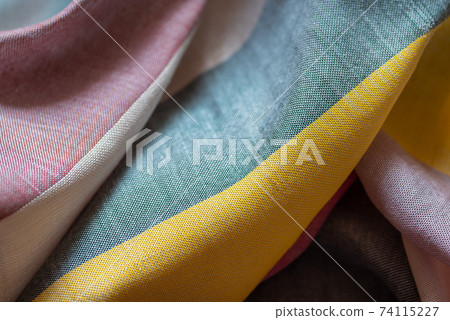 Crumpled multi colored striped fabric textile background Crumpled multi colored striped fabric textile background 74115227