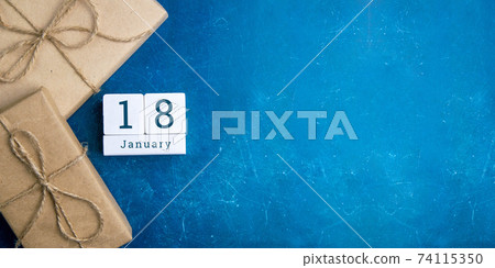 January 18 on the wooden calendar.The eighteenth day of the winter month, a calendar for the workplace. Winter January 18 on the wooden calendar.The eighteenth day of the winter month, a calendar for the workplace. Winter 74115350