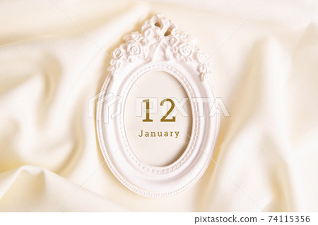 January 12 on the wooden calendar.The twelfth day of the winter month, a calendar for the workplace. Winter January 12 on the wooden calendar.The twelfth day of the winter month, a calendar for the workplace. Winter 74115356
