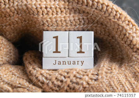 January 11 on the wooden calendar.The eleventh day of the winter month, a calendar for the workplace. Winter 74115357