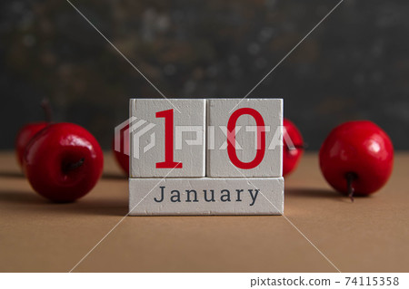 January 10 on the wooden calendar.The tenth day of the winter month, a calendar for the workplace. Winter January 10 on the wooden calendar.The tenth day of the winter month, a calendar for the workplace. Winter 74115358