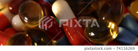 Many multicolored pills and capsules close-up macro background 74116269