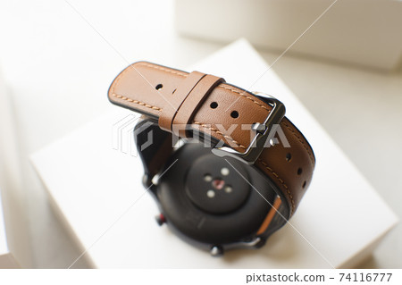 Brown leather watch strap of smart watch on white box 74116777