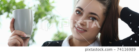 Beautiful lady sitting on sofa 74116989