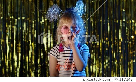 Trendy girl raising hands in surprise looking at camera with big eyes, shocked by victory, say wow Trendy girl raising hands in surprise looking at camera with big eyes, shocked by victory, say wow 74117142