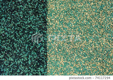 Dark and light green textured granular background 74117294