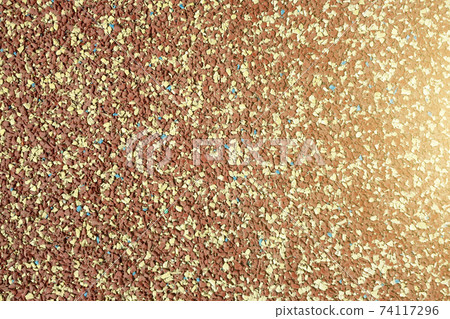 Background of granular stone texture in brown and yellow colors with lens flare. Grain material of wall or flooring. Background of granular stone texture in brown and yellow colors with lens flare. Grain material of wall or flooring. 74117296