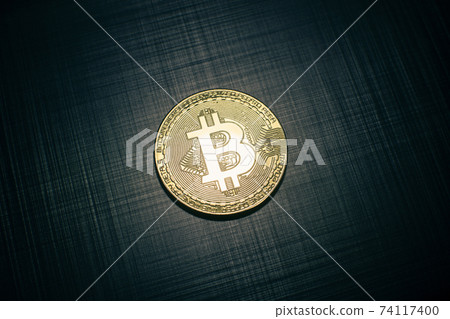 Golden bitcoin on dark blue metallic striped texture background 74117400