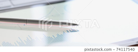 On table is a keyboard tablet and diary. 74117540