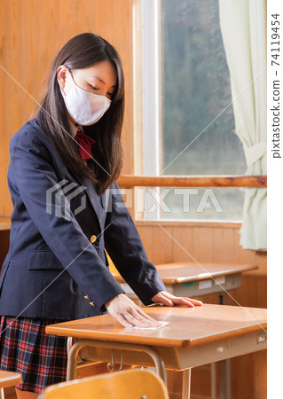 High school girl high school student disinfecting desk High school girl high school student disinfecting desk 74119454