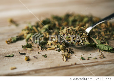 a spoon of chamomile flowers a spoon of chamomile flowers 74119567
