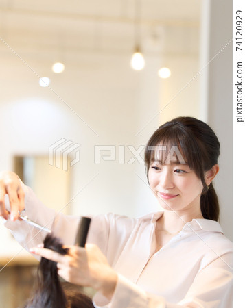 Hair stylist who cuts the customer's hair Hair stylist who cuts the customer's hair 74120929