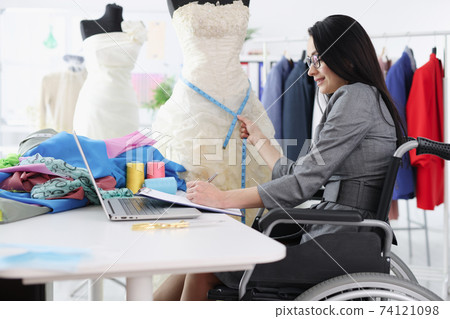 Disabled woman in wheelchair taking measurements from wedding dress Disabled woman in wheelchair taking measurements from wedding dress 74121098