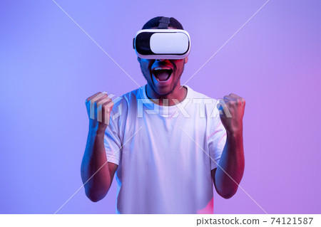 Euphoric Black Guy Playing Video Game In VR Glasses, Exclaiming With Excitement 74121587