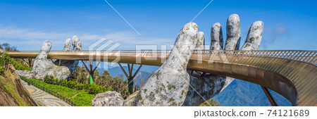 Famous tourist attraction - Golden bridge at the top of the Ba Na Hills, Vietnam BANNER, LONG FORMAT 74121689