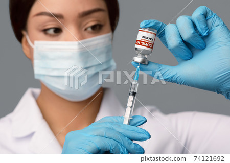Coronavirus Immunization. Doctor With Syringe Taking Dose Of Covid-19 Vaccine From Vial Coronavirus Immunization. Doctor With Syringe Taking Dose Of Covid-19 Vaccine From Vial 74121692