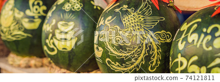BANNER, LONG FORMAT Water melons with festive engraving on Tet Eve. Tet is Lunar New Year and celebrated during four days in Vietnam TEXT TRANSLATION from Vietnamese: Congratulations on the Vietnamese BANNER, LONG FORMAT Water melons with festive engraving on Tet Eve. Tet is Lunar New Year and celebrated during four days in Vietnam TEXT TRANSLATION from Vietnamese: Congratulations on the Vietnamese 74121811