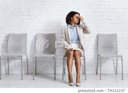 African American woman in business outfit tired of waiting for job interview, having headache at office hall, copy space 74122237