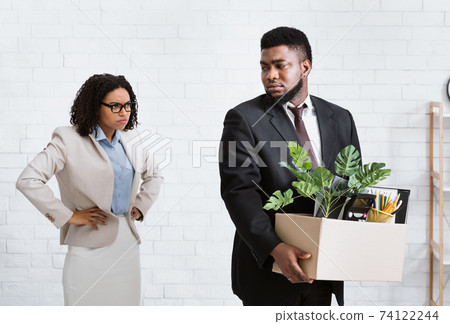 Angry black lady boss firing young male employee at office. Financial crisis and unemployment concept 74122244