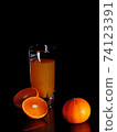 Orange juice in a clear glass. 74123391