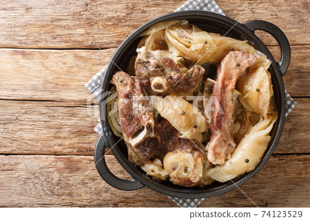 Norwegian cuisine lamb stew with cabbage and pepper in a pan. Horizontal top view Norwegian cuisine lamb stew with cabbage and pepper in a pan. Horizontal top view 74123529