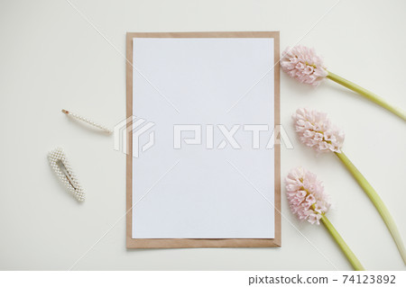 Wedding or birthday flat lay composition with pink flowers and blank paper card, mockup, invitations. Flatlay, top view, copy space Wedding or birthday flat lay composition with pink flowers and blank paper card, mockup, invitations. Flatlay, top view, copy space 74123892