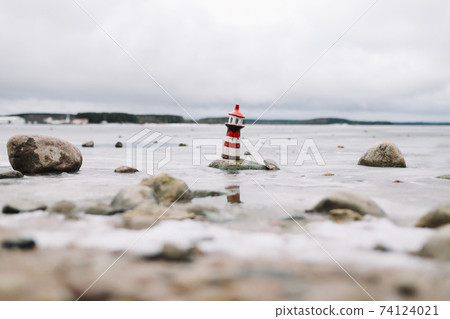 Frozen winter sea with decorative lighthouse. Nautical lifestyle. Winter, Sea, Travel, adventure, holidays and vacation concept. Travel in 2021 Frozen winter sea with decorative lighthouse. Nautical lifestyle. Winter, Sea, Travel, adventure, holidays and vacation concept. Travel in 2021 74124021