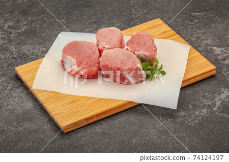 Raw pork medallion served rosemary Raw pork medallion served rosemary 74124197